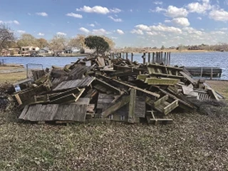 Storm debris piled up in front of lake